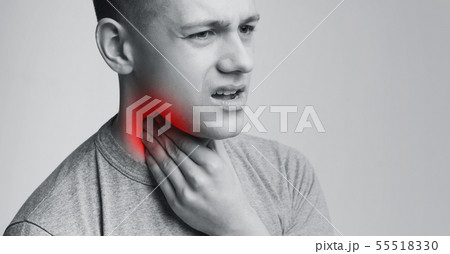 Man suffering with sore throat, touching his neck with hand Man suffering with sore throat, touching his neck with hand 55518330
