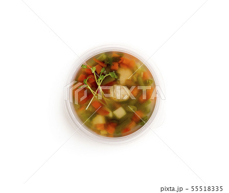 Vegetables soup in to go plate in the center of white 55518335