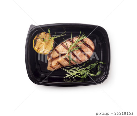Freshly coocked fish on grill with lemon in black box 55519153