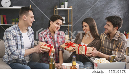 Friends presenting gifts to a girl celebrating her birthday 55519573