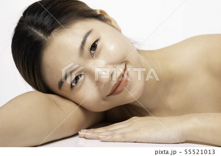 Asian Beauty woman smile with clean skin on white Asian Beauty woman smile with clean skin on white 55521013