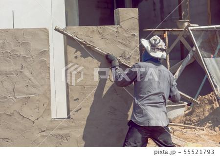 Construction workers plastering building wall Construction workers plastering building wall 55521793