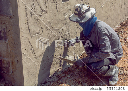 Construction workers plastering building wall Construction workers plastering building wall 55521808