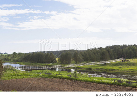 View over the suspension bridge through the river 55524055