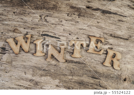 Word WINTER on wooden background 55524122