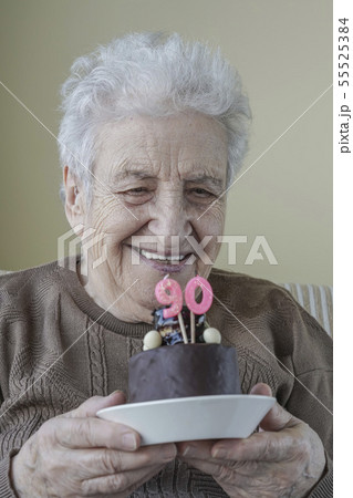 Senior woman with her birthday cake for age ninety Senior woman with her birthday cake for age ninety 55525384
