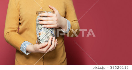 Jar full of money in hands. Saving money concept 55526113