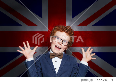 Funny mischievous child boy student against the UK 55526114