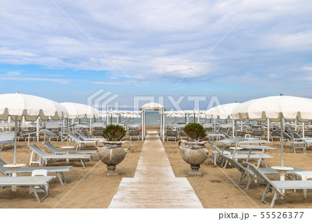 Empty beach with white sunshades, Italy, Riccione Empty beach with white sunshades, Italy, Riccione 55526377