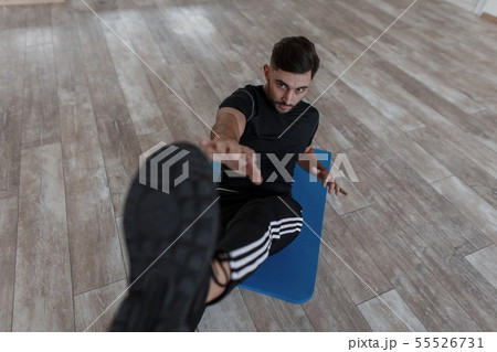 Athletic healthy young man in black sportswear Athletic healthy young man in black sportswear 55526731