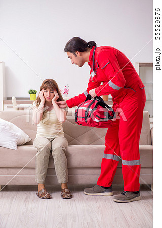 Young male paramedic visiting young woman Young male paramedic visiting young woman 55529376