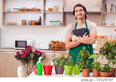 Young handsome man cultivating flowers at home 55529797