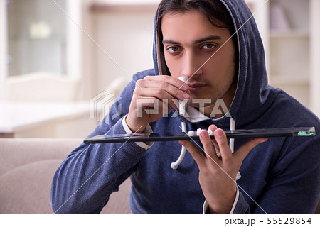 Young man having problems with narcotics at home 55529854