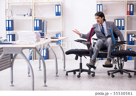 Young handsome employee in wheelchair working in the office Young handsome employee in wheelchair working in the office 55530561