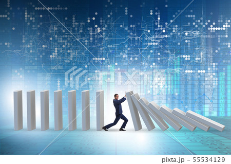 Businessman preventing domino effect in business concept Businessman preventing domino effect in business concept 55534129