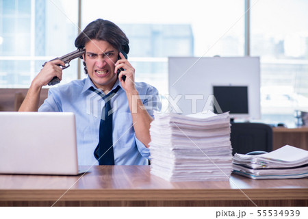 Young employee unhappy with excessive work 55534939