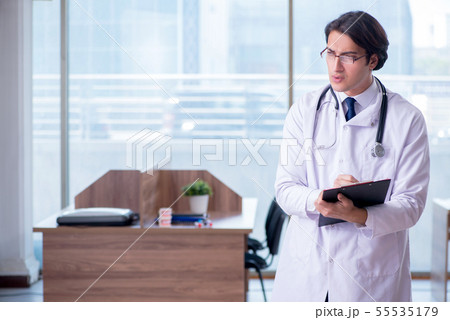 Young handsome doctor working in the clinic Young handsome doctor working in the clinic 55535179
