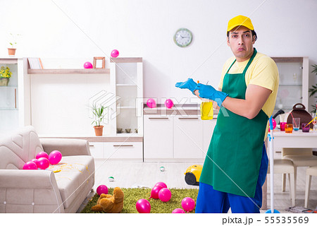 Young male contractor doing housework after party Young male contractor doing housework after party 55535569
