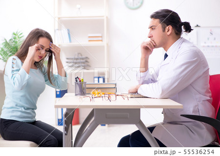 Young woman visiting male doctor oculist 55536254