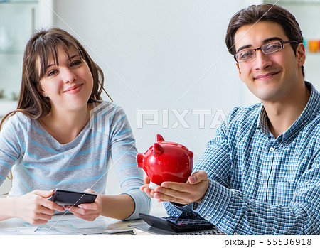 Young couple looking at family finance papers 55536918