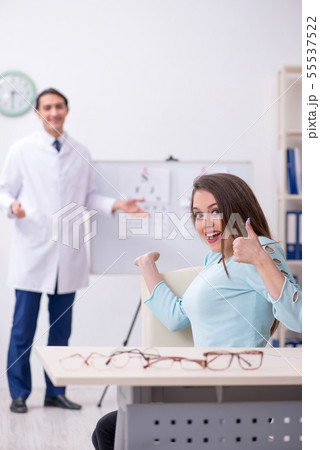 Young woman visiting male doctor oculist 55537522