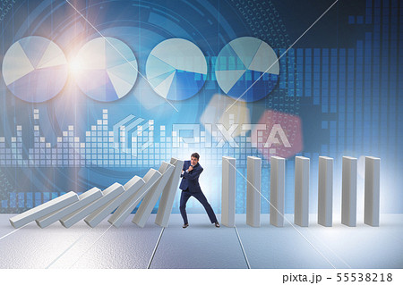 Businessman preventing domino effect in business concept 55538218