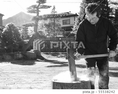 An older man making mochi in the winter An older man making mochi in the winter 55538242