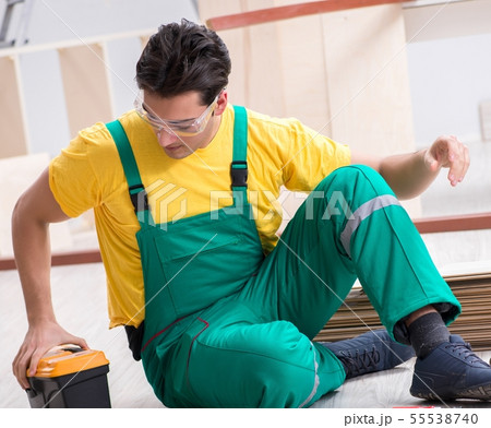Contractor working on laminate wooden floor Contractor working on laminate wooden floor 55538740