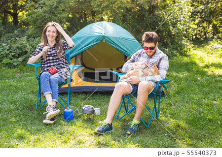 People, tourism and nature concept - Couple having fun on camping trip 55540373