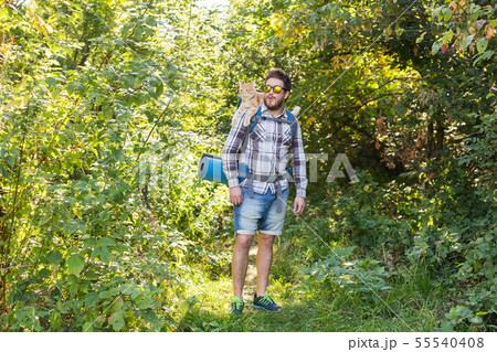 Adventures, summer tourism and nature concept - tourist arriving to a camping with his cat 55540408