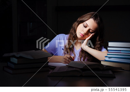 Young female student preparing for exams late at home 55541395