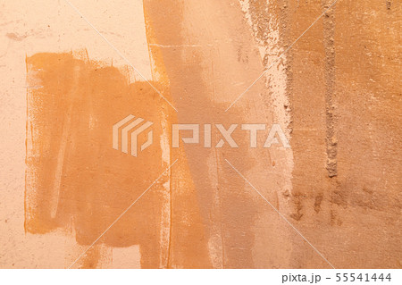 An orange unevenly painted beton wall An orange unevenly painted beton wall 55541444