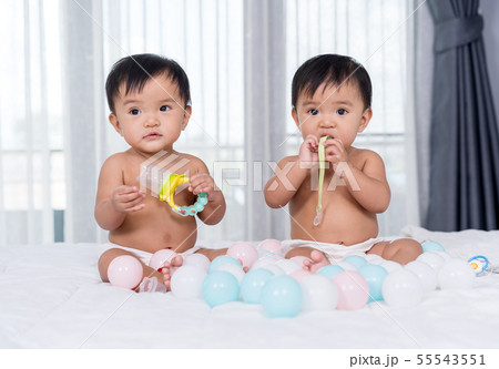cheerful twin babies on bed cheerful twin babies on bed 55543551