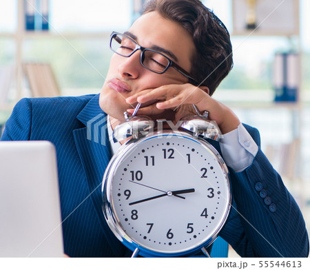 Businessman with giant clock failing to meet deadlines and missi 55544613