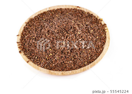 The flax seeds in a wooden plate isolated on a white background The flax seeds in a wooden plate isolated on a white background 55545224