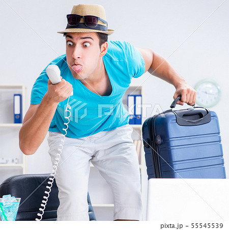 Businessman preparing for vacation in the office Businessman preparing for vacation in the office 55545539