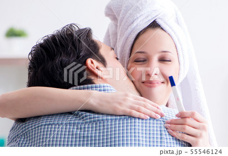 Wife and husband looking at pregnancy test Wife and husband looking at pregnancy test 55546124
