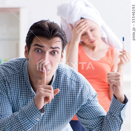 Wife and husband looking at pregnancy test Wife and husband looking at pregnancy test 55546293
