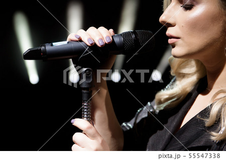 Singer and microphone. Singer woman on stage. 55547338