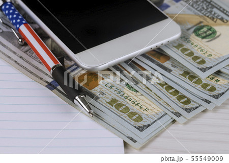 Phone and pen on money. Finance concept. Phone and pen on money. Finance concept. 55549009