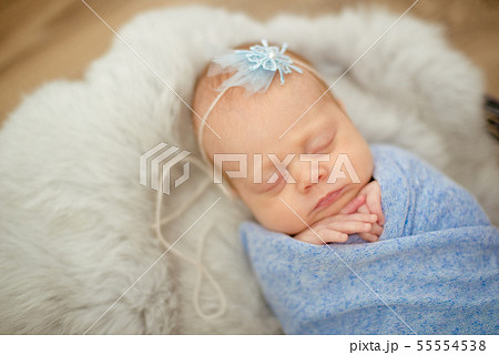 newborn baby girl in blue blanket in a  basket 55554538