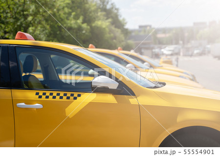 Image of yellow taxi on street in summer 55554901