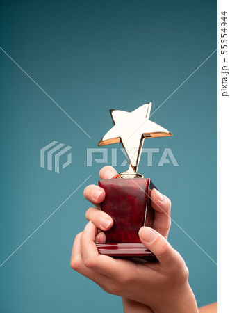 Picture of hands of man raising goblet with star Picture of hands of man raising goblet with star 55554944