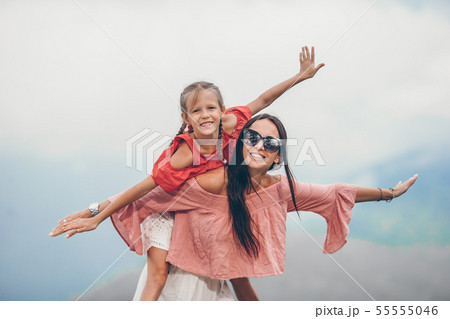 Beautiful happy family in mountains in the background of fog. Beautful landscape 55555046