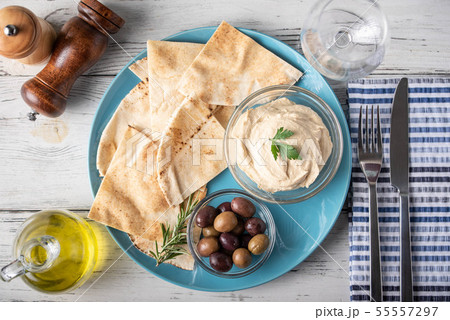 hummus with pita bread on blue plate 55557297