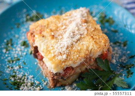 greek moussaka on blue plate in white wooden greek moussaka on blue plate in white wooden 55557311