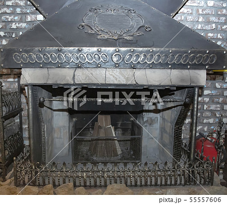 Photo background fireplace stove of iron welded gray welded decorated with metallic decor Photo background fireplace stove of iron welded gray welded decorated with metallic decor 55557606