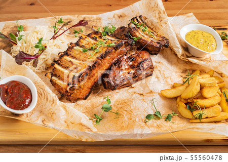 grilled ribs with potatoes and sauce grilled ribs with potatoes and sauce 55560478