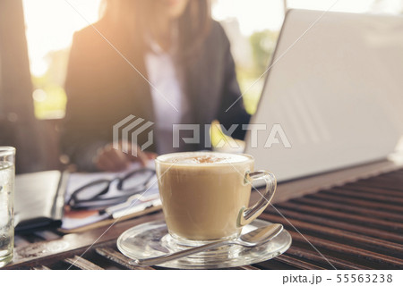 Coffee time, beautiful woman using mobile phone in Coffee time, beautiful woman using mobile phone in 55563238