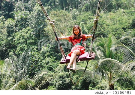 Young pretty Asian woman is swinging on the cliff Young pretty Asian woman is swinging on the cliff 55566495